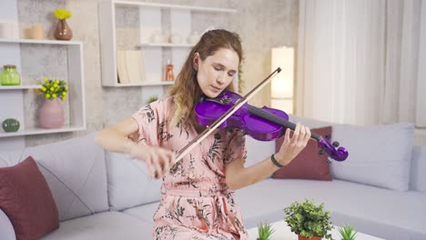 Young-musician-woman-playing-her-violin-at-home,-composing-songs,-producing.